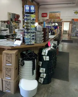 Coils of drip tubing and boxed fittings stacked in front of the Foothills Irrigation sales counter
