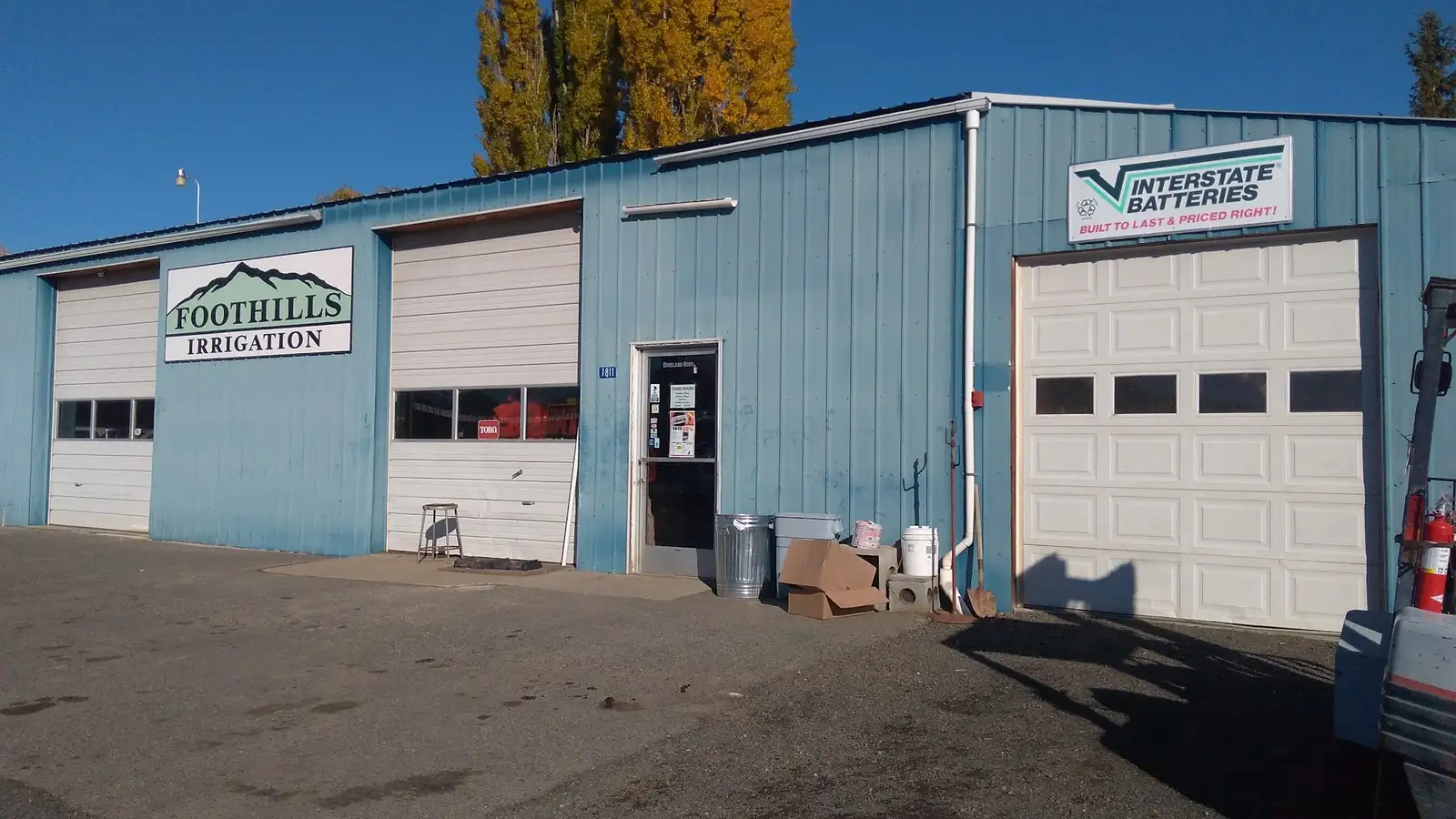 The Foothills Irrigation store front with its mountain sign under a clear Cowiche sky
