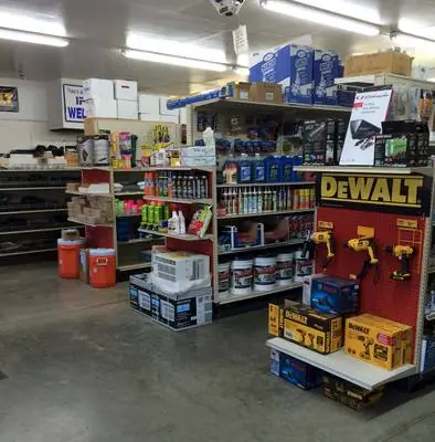 Inside the store: a DeWalt endcap, paint and fluids shelving and water coolers under shop lights